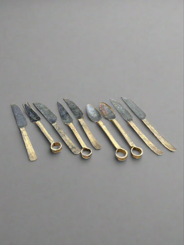Primitive iron and gold cutlery with studded handles, suitable for medieval-style dressing.
