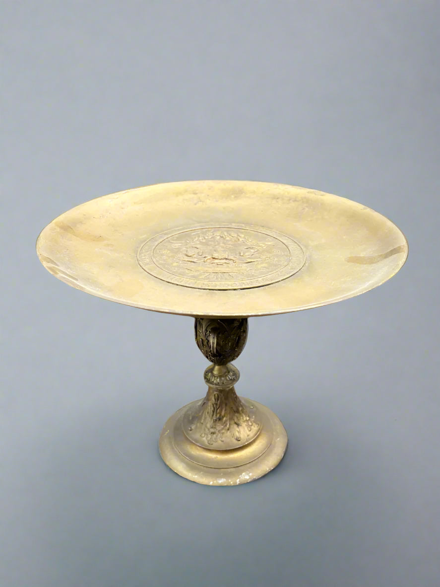A brass tazza pedestal plate with a decorative centre and stand, circa early 20th century.