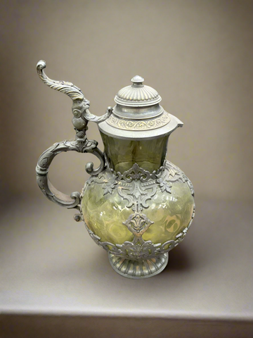 A German smoked green glass flagon with decorative pewter mounts.