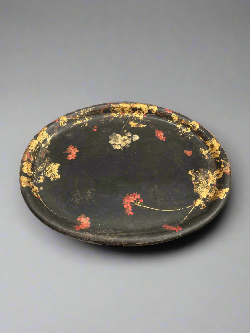 Victorian black oval toleware tray with a red and gilt chinoiserie pattern.