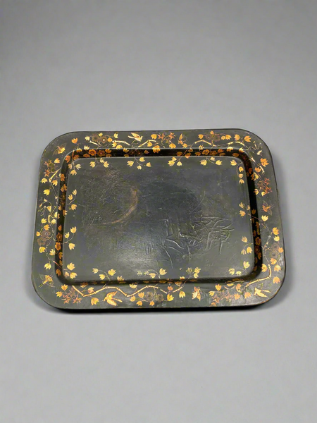 A black Victorian serving tray with toleware-style gilt flower decoration.