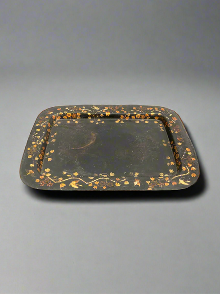 A black Victorian serving tray with toleware-style gilt flower decoration.