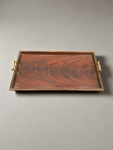 A large, rectangular, wooden, butler's serving tray with brass handles.