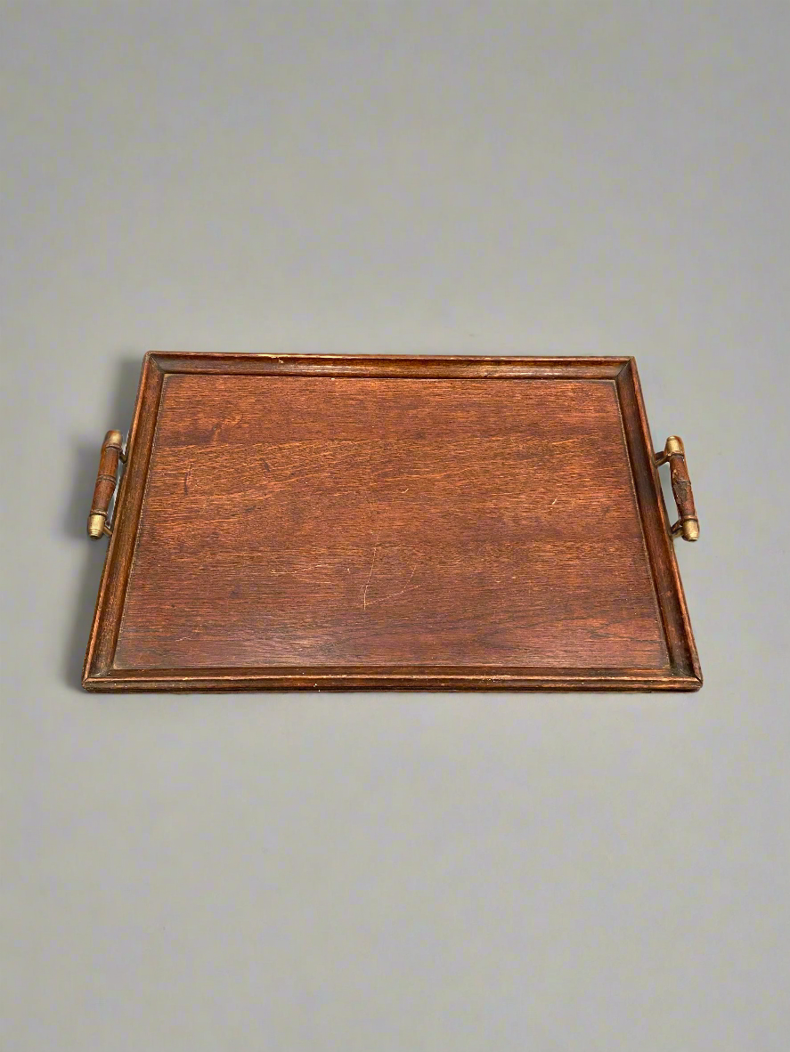 An antique, English, oak butler's tray with brass tipped handles.