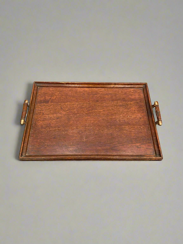 An antique, English, oak butler's tray with brass tipped handles.