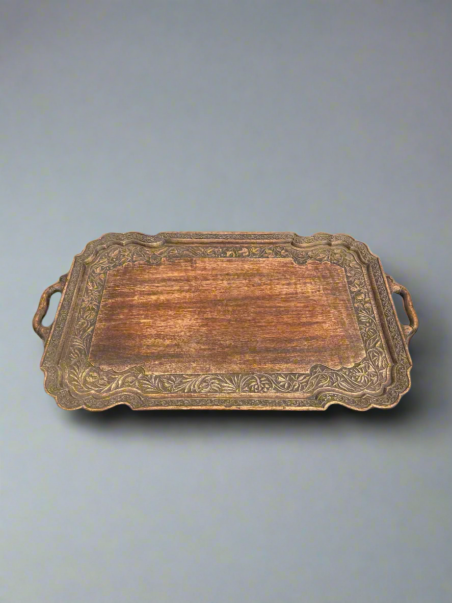 A large, ornate, wooden tray with Eastern-style decorative carvings.