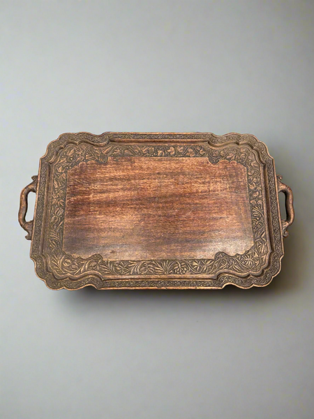 A large, ornate, wooden tray with Eastern-style decorative carvings.