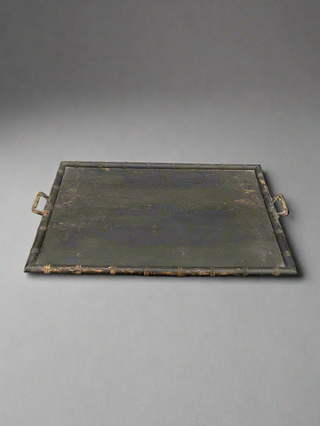 An antique, rectangular, black, bamboo tray with ornate brass handles.