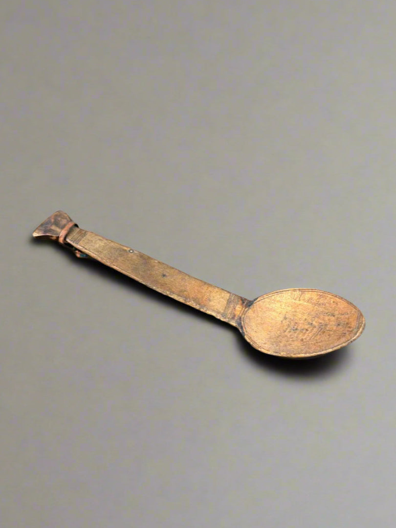 A vintage, wooden, African, folk spoon with primitive carvings.