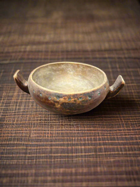 An antique, Masai-African, wooden milk/hutu bowl with two curved handles.