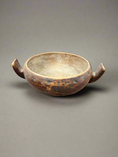 An antique, Masai-African, wooden milk/hutu bowl with two curved handles.
