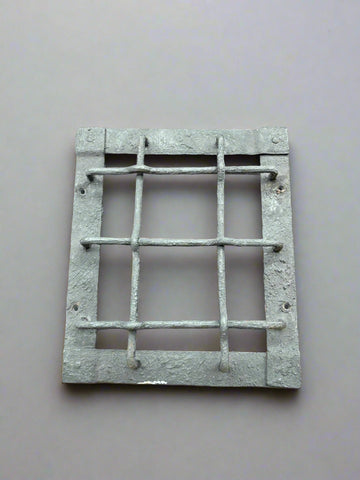 A larger, latticed, cast iron door grill with a textured finish.