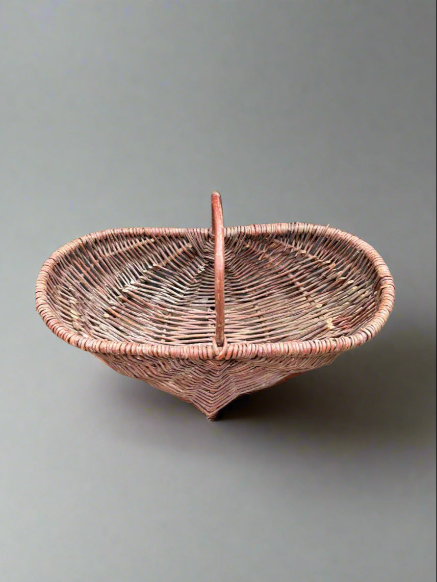 A long oblong wicker harvest basket trug.