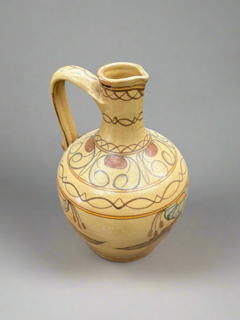A vintage, yellow, Portugese jug vase with a hand painted pattern, circa 1990s.