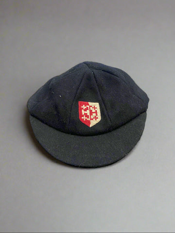A traditional vintage boy's school cap with a sewn school crest.