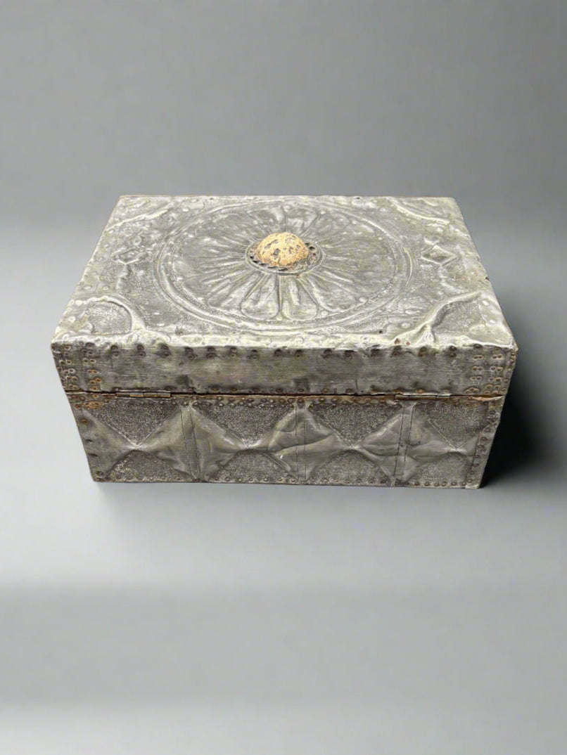 An antique pewter jewellery/humidor box with a cast floral pattern on the lid and textured sides.