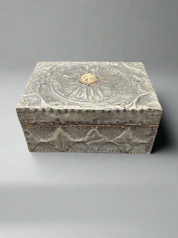 An antique pewter jewellery/humidor box with a cast floral pattern on the lid and textured sides.
