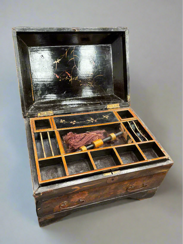 A detailed Japanese-style haberdashery chest with a sectioned and lacquered interior.