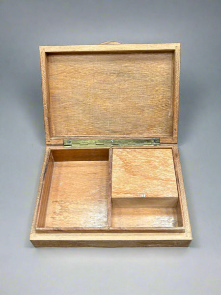 A wooden storage box with an Art Nouveau-style inlaid design on the lid.