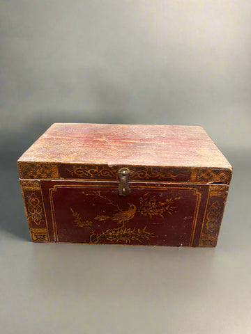 A traditional, antique, Chinese, wooden document chest with an Asian design painted in red stain/paint.