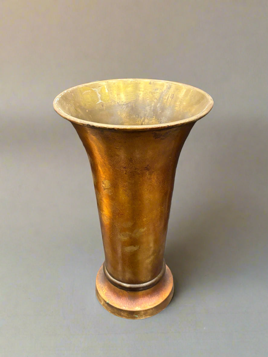 A tall amber bronze vase with a mottled iridescent finish and a gold interior.