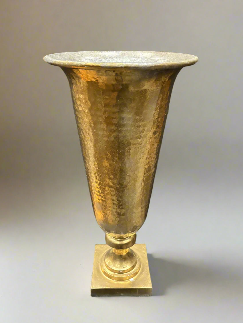 A pair of tall and large brass urn vases with a hammered finish.