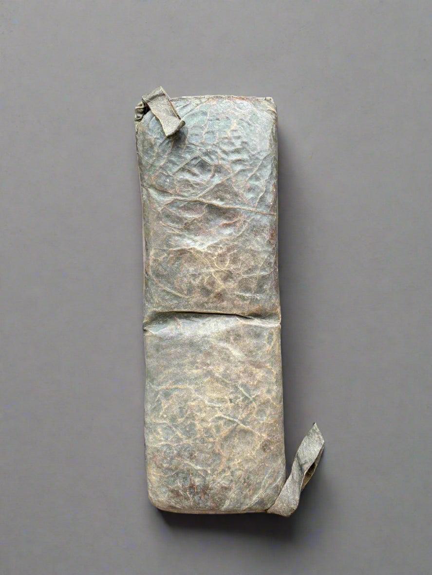 A brown leather bench cushion pad, in an aged condition.