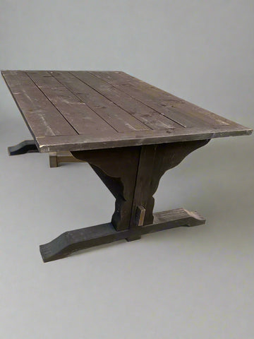 A rustic refectory-style dining table with a slatted top, finished with a dark brown stain.
