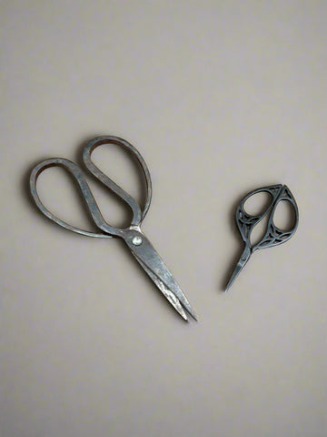 Two pairs of vintage scissors; the pair on the left are garden pruning scissors and the right hand pair are needlework sewing scissors.