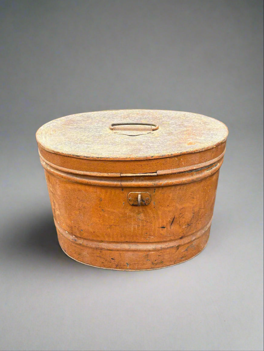 A Victorian, oval-shaped, brown, metal hat box.