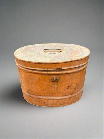A Victorian, oval-shaped, brown, metal hat box.