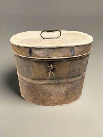 A rusty Victorian metal hat/wig box, circa 19th century. It could also be a military helmet box.