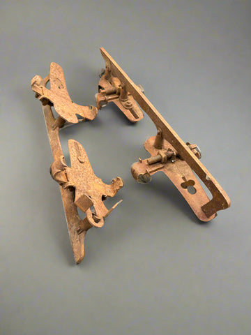 A pair of vintage, metal, clamp-on ice skates with a rusted patina, circa 1950s.