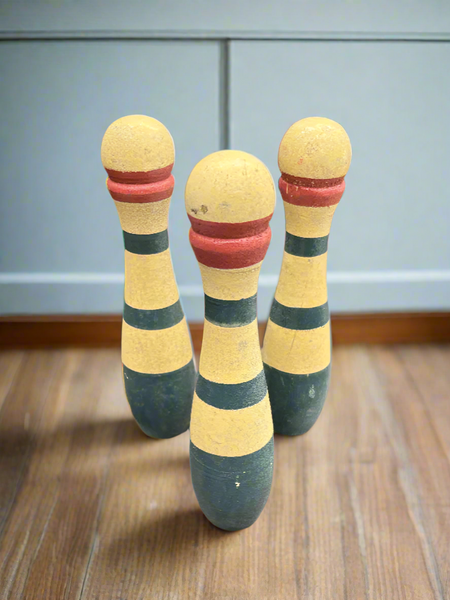 A large set of French wooden toy skittles with hand painted red and blue stripes, circa 1920s.