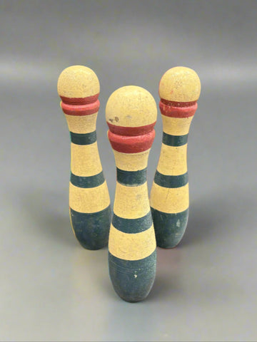 A large set of French wooden toy skittles with hand painted red and blue stripes, circa 1920s.