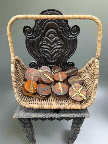 A collection of medium-sized, antique, wood and brass fishing reels.