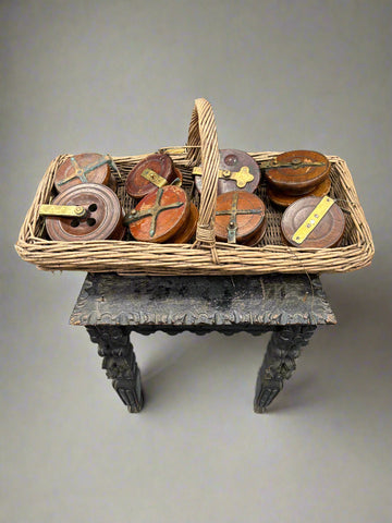 A collection of large, antique, wood and brass fishing reels.