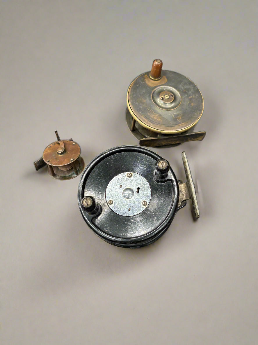 A selection of miscellaneous, antique, metal fishing reels.