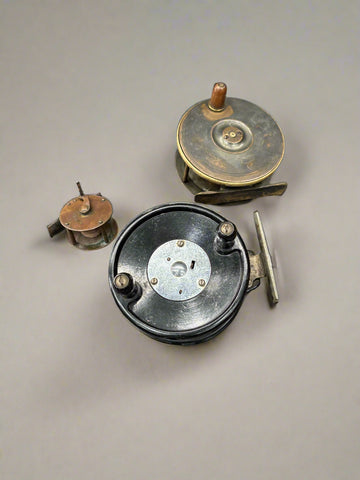 A selection of miscellaneous, antique, metal fishing reels.