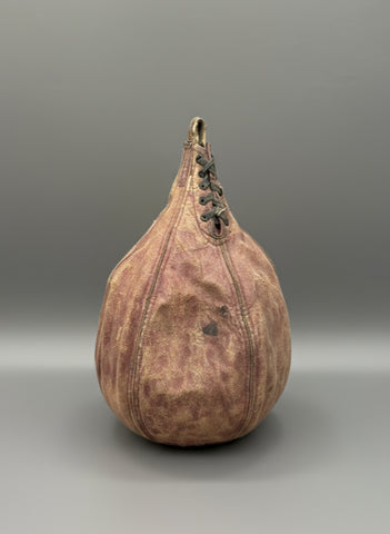 A small, vintage, leather, speed punching bag with a lace up front, circa 1930s-40s.