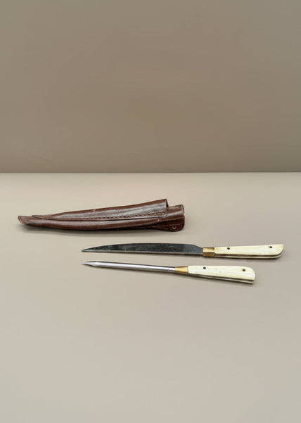 A letter opening set (a knife and pricker or spike) in a leather sheaf.