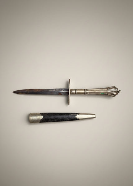 An antique silver and leather letter opener.
