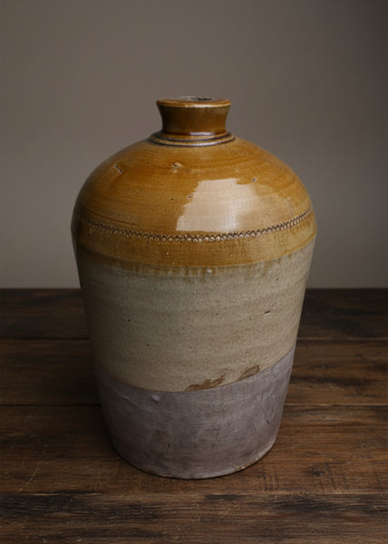 A large stoneware flagon jug, showcasing three different tones and textures.