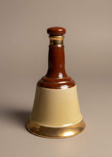 A set of vintage Bells scotch whisky decanter bottles, in an aged condition.