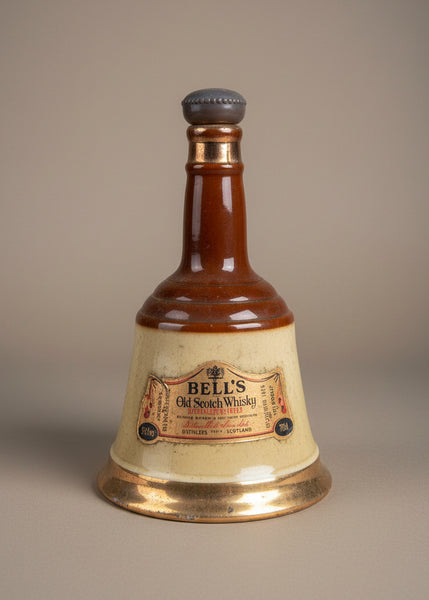 A set of vintage Bells scotch whisky decanter bottles, in an aged condition.