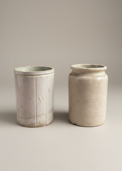 A set of antique ceramic kitchen preserving jars in varying natural stoneware colours.