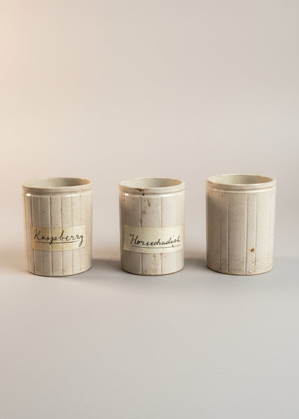 A set of antique ceramic kitchen preserving jars in varying natural stoneware colours.