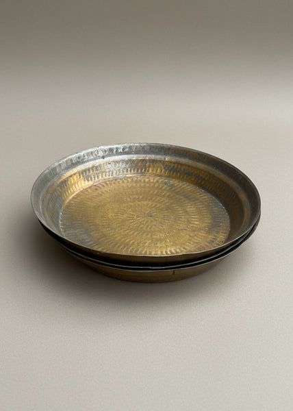 A trio of Indian brass paraats/ chapatti plates with a hammered finish, used for kneading dough.