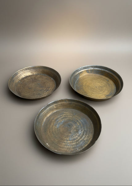 A trio of Indian brass paraats/ chapatti plates with a hammered finish, used for kneading dough.