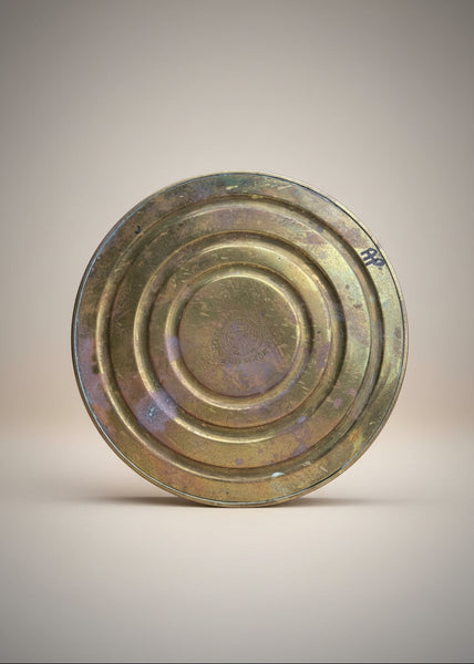 A decorative brass tazza bowl sitting on a pedestal by Daalderop of Holland.
